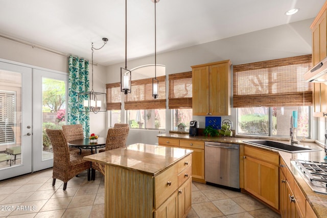 22232 N 48th St, Phoenix, AZ 85054 - kitchen featuring light tile patterned flooring, a center island, a sink, hanging light fixtures, and stainless steel appliances