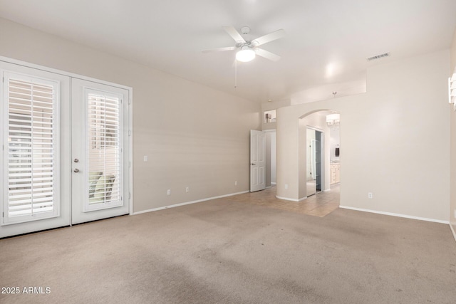 22232 N 48th St, Phoenix, AZ 85054 - unfurnished living room featuring carpet flooring, arched walkways, french doors, a ceiling fan, and baseboards