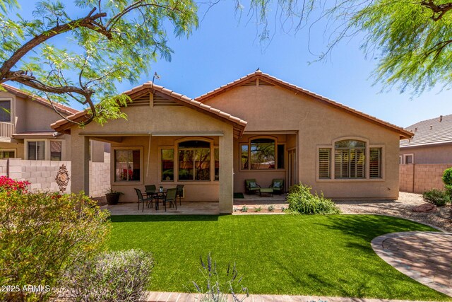 22232 N 48th St, Phoenix, AZ 85054 - back of house featuring a lawn, a patio, fence, and stucco siding