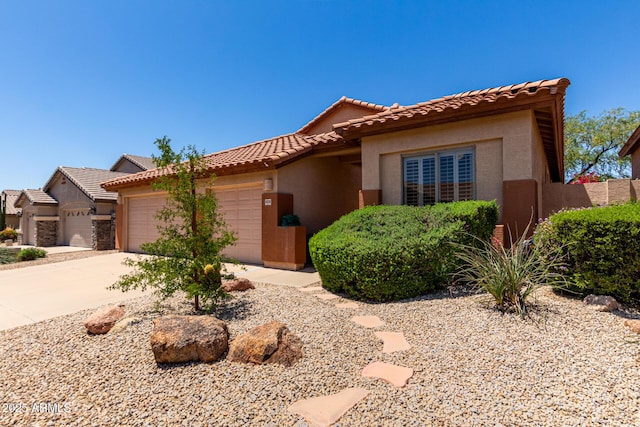 22232 N 48th St, Phoenix, AZ 85054 - mediterranean / spanish-style house featuring an attached garage, driveway, a tile roof, and stucco siding