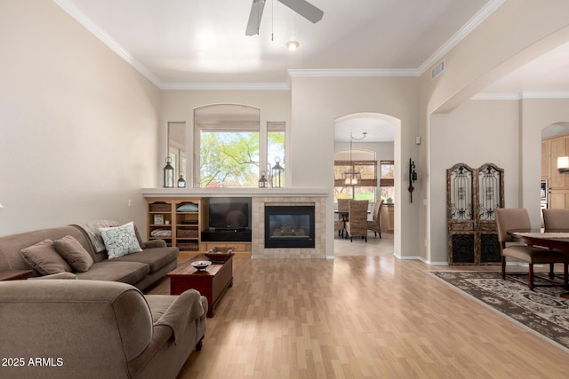 22232 N 48th St, Phoenix, AZ 85054 - living room with visible vents, a ceiling fan, ornamental molding, light wood-style floors, and arched walkways