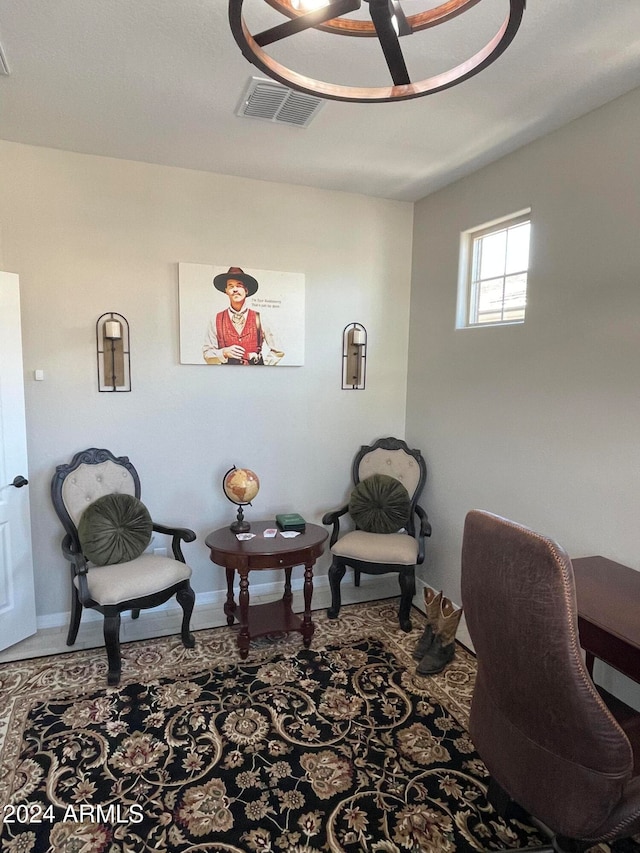 office with carpet and an inviting chandelier