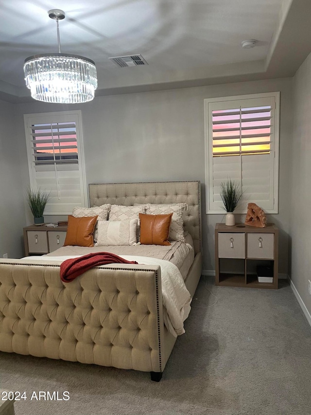 bedroom featuring carpet flooring and an inviting chandelier