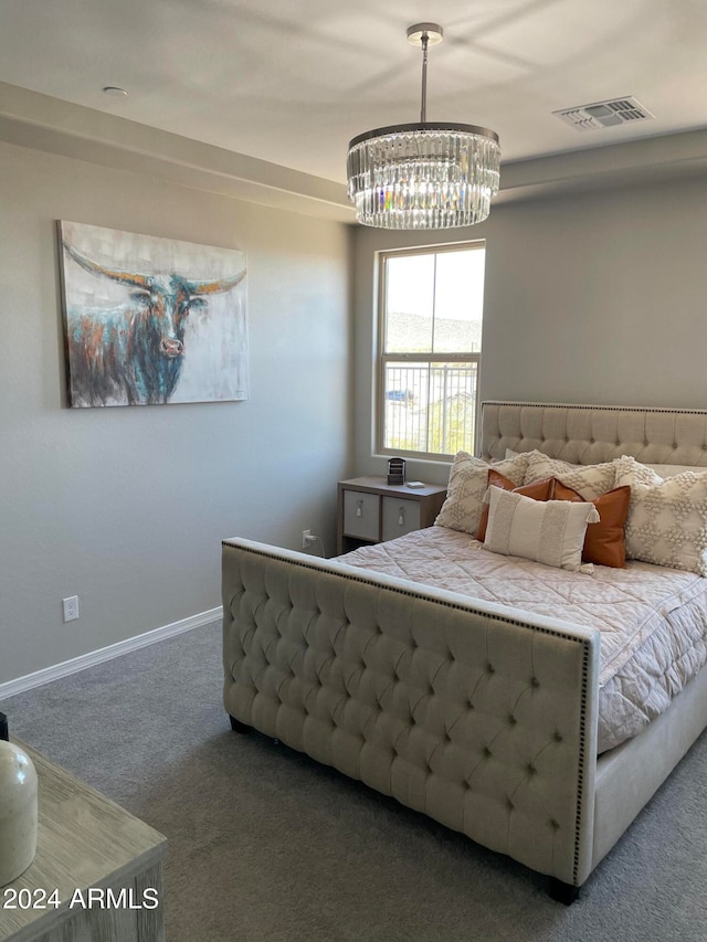 bedroom featuring a notable chandelier and carpet