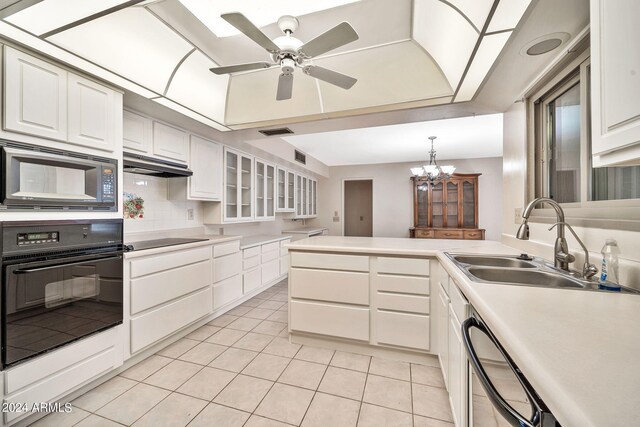 kitchen with white cabinets, light tile patterned flooring, sink, black appliances, and ceiling fan with notable chandelier