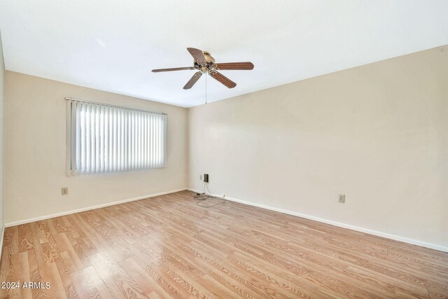 spare room with ceiling fan and light hardwood / wood-style floors