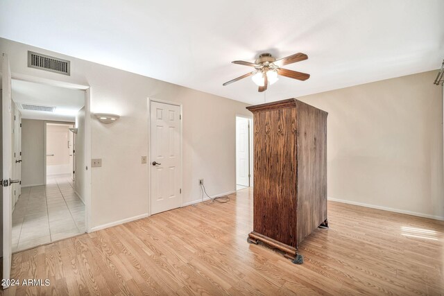 empty room with light wood-type flooring and ceiling fan