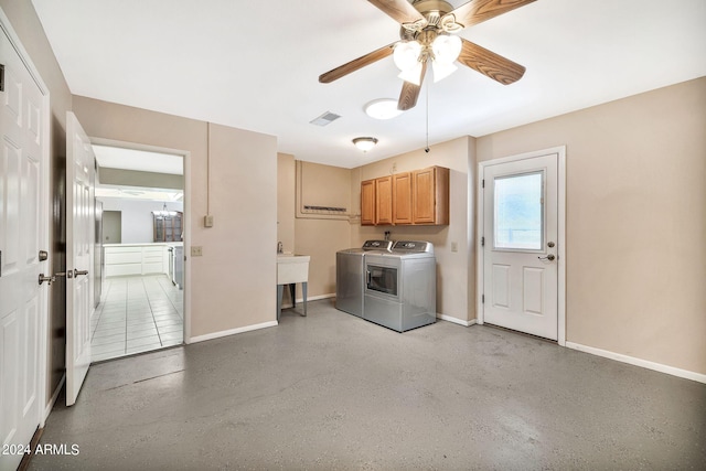 washroom featuring washer and dryer, ceiling fan, and cabinets