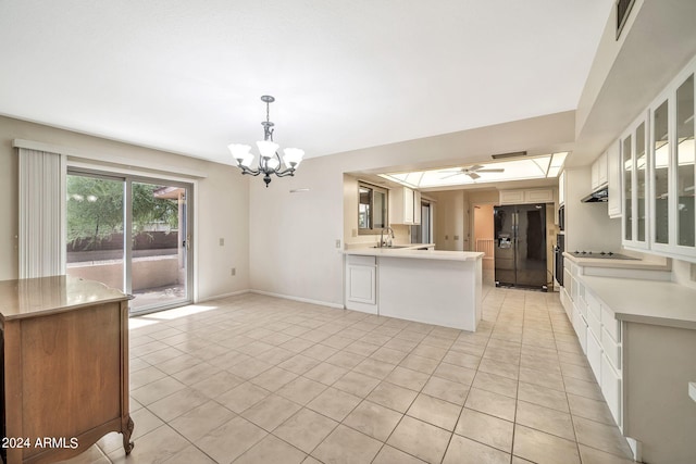 kitchen featuring white cabinets, hanging light fixtures, kitchen peninsula, black appliances, and ceiling fan with notable chandelier