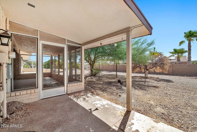 view of patio featuring a sunroom