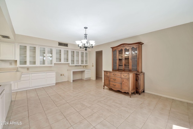 unfurnished dining area with a chandelier and light tile patterned floors