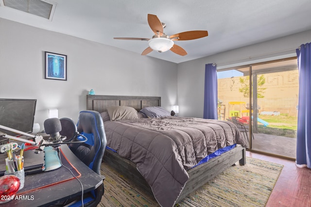 bedroom featuring access to outside, ceiling fan, and dark hardwood / wood-style flooring