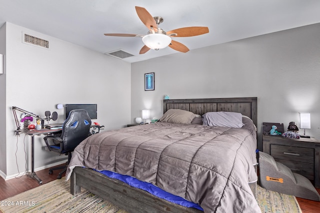 bedroom with dark hardwood / wood-style floors and ceiling fan