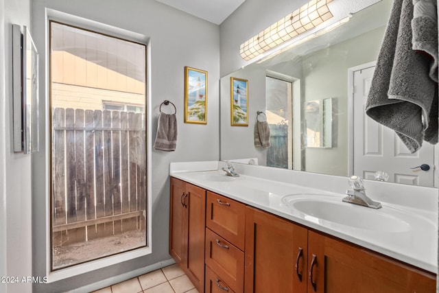 bathroom featuring dual bowl vanity and tile flooring