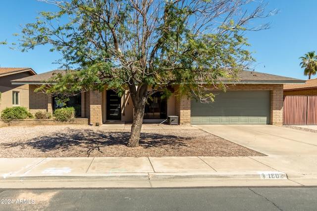 view of front of home featuring central AC and a garage