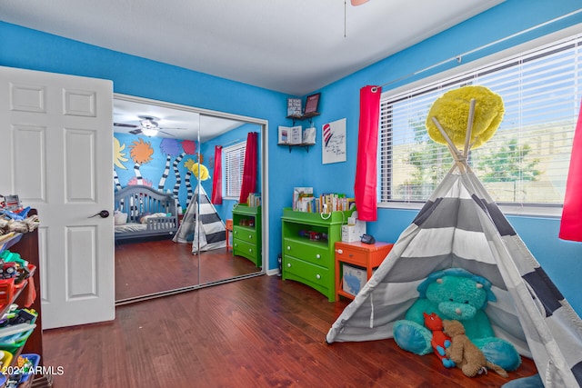 playroom featuring dark hardwood / wood-style flooring and ceiling fan