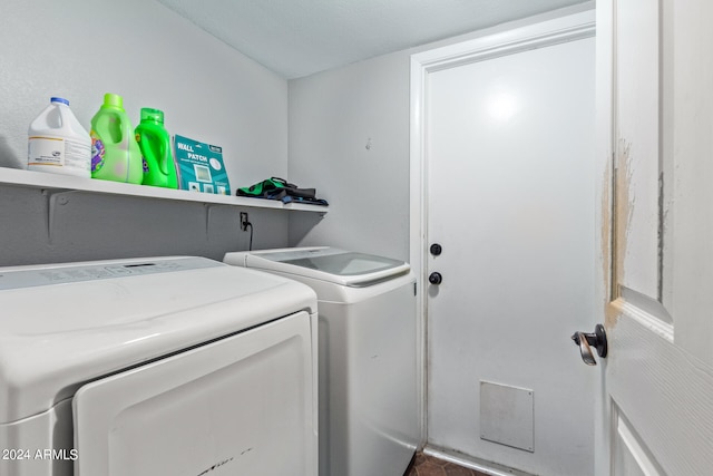 washroom featuring independent washer and dryer and a textured ceiling