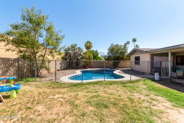 view of swimming pool featuring a lawn and a patio area