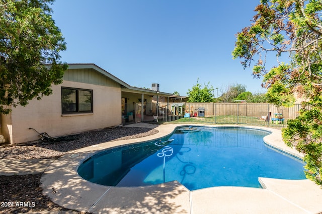 view of swimming pool with a patio