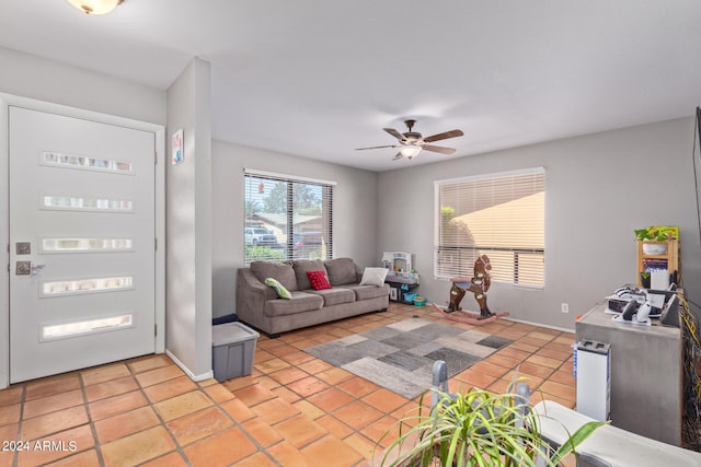 tiled living room with ceiling fan