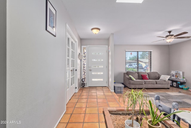 foyer with light tile flooring and ceiling fan