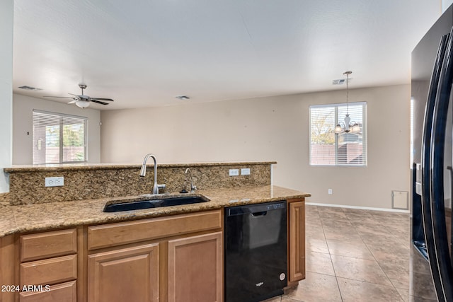 kitchen featuring a healthy amount of sunlight, sink, black appliances, and ceiling fan with notable chandelier