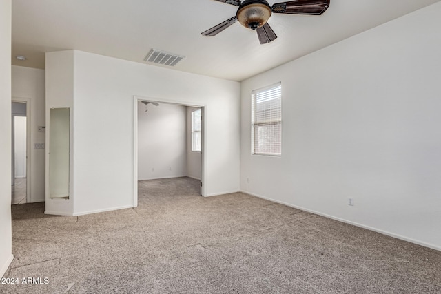 unfurnished bedroom with ceiling fan and light colored carpet