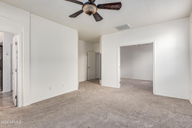 unfurnished bedroom with ceiling fan, a closet, and light colored carpet