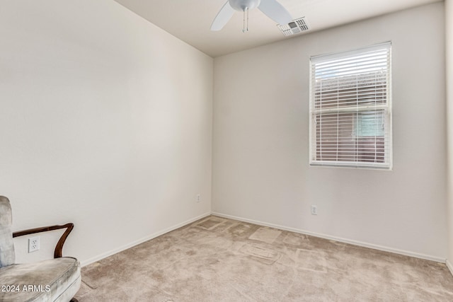 unfurnished room featuring light colored carpet and ceiling fan