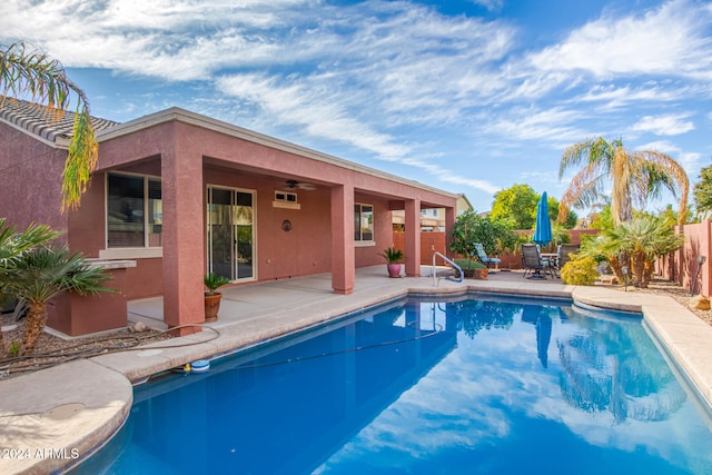 view of swimming pool featuring ceiling fan and a patio