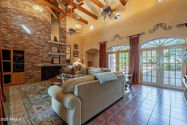 tiled living room featuring a healthy amount of sunlight, high vaulted ceiling, french doors, and beamed ceiling