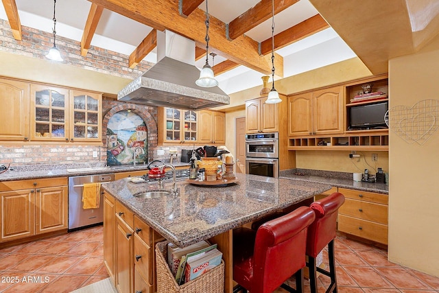 kitchen featuring light tile patterned floors, a breakfast bar, appliances with stainless steel finishes, an island with sink, and island exhaust hood