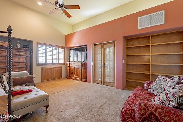 living area featuring high vaulted ceiling, ceiling fan, and carpet flooring