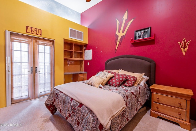 carpeted bedroom with access to outside and french doors