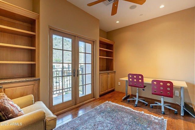 home office with wood-type flooring, french doors, and ceiling fan