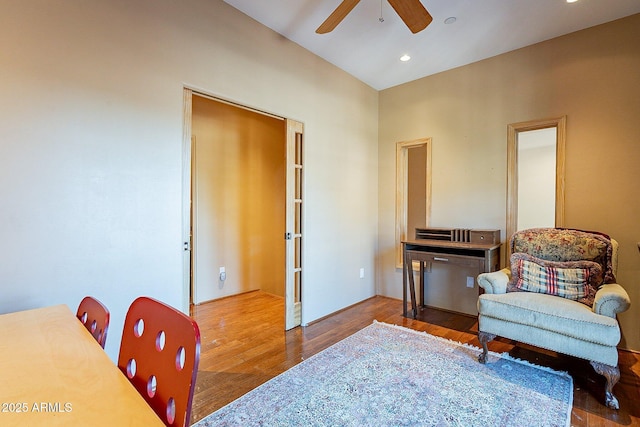 living area with hardwood / wood-style floors and ceiling fan