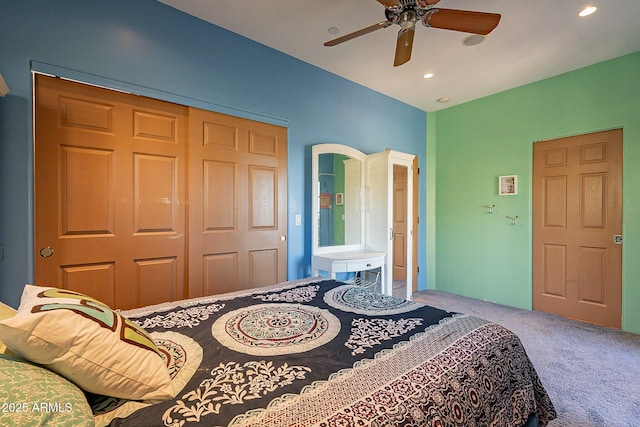 carpeted bedroom featuring ceiling fan and a closet