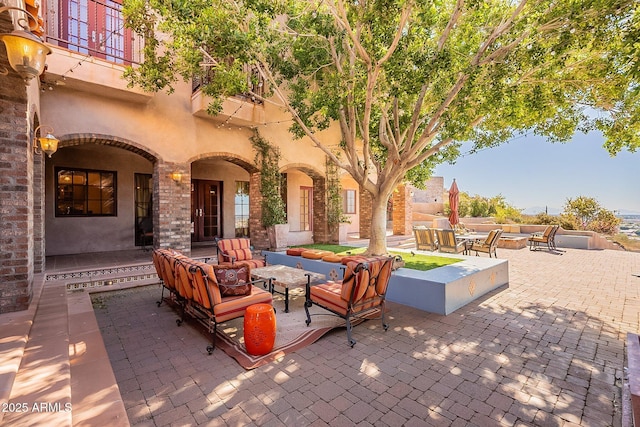 view of patio / terrace featuring an outdoor living space with a fire pit