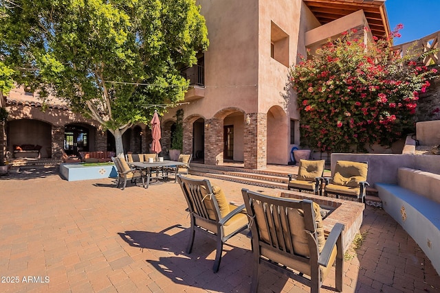 view of patio with an outdoor living space with a fireplace