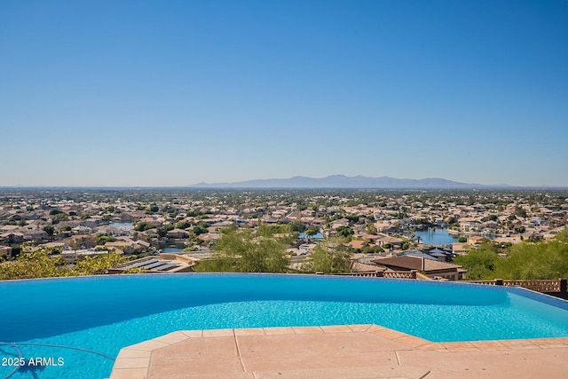 view of pool featuring a water and mountain view