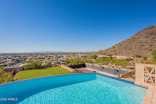 view of swimming pool with a mountain view