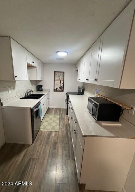 kitchen with sink, white cabinetry, and dark hardwood / wood-style flooring