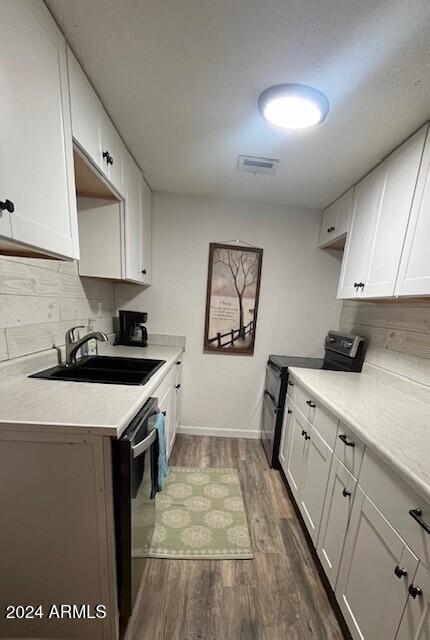 kitchen with black electric range oven, sink, white cabinets, and dark hardwood / wood-style floors