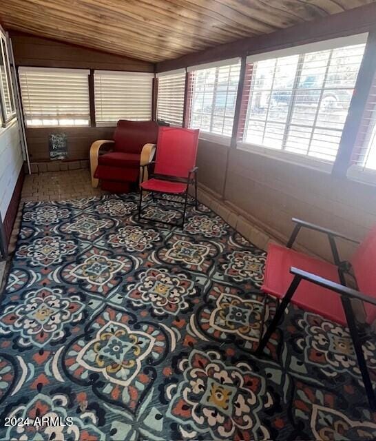 sunroom / solarium with lofted ceiling and wooden ceiling