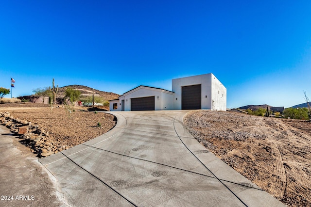 view of front facade with a mountain view and a garage