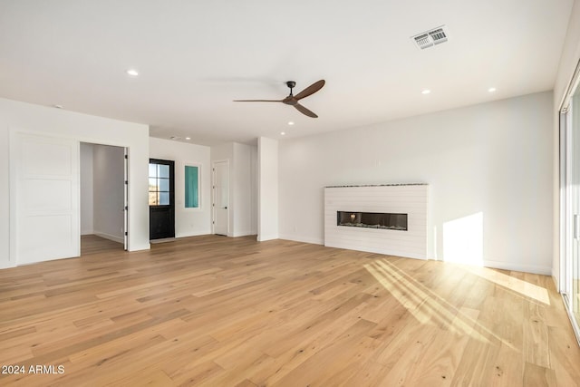 unfurnished living room with light hardwood / wood-style flooring and ceiling fan