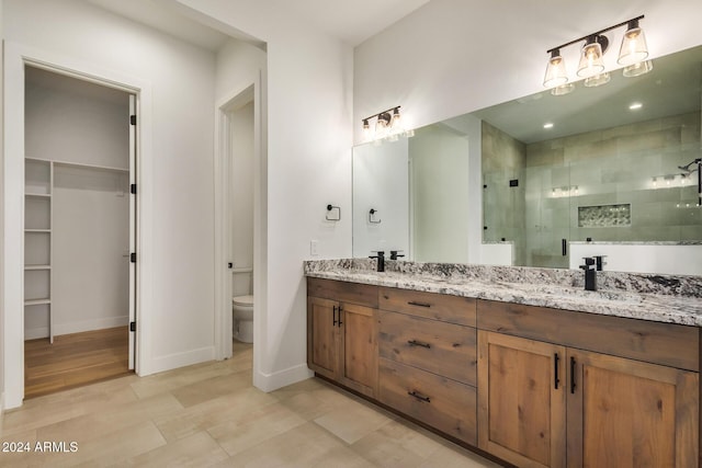 bathroom with wood-type flooring, vanity, toilet, and walk in shower