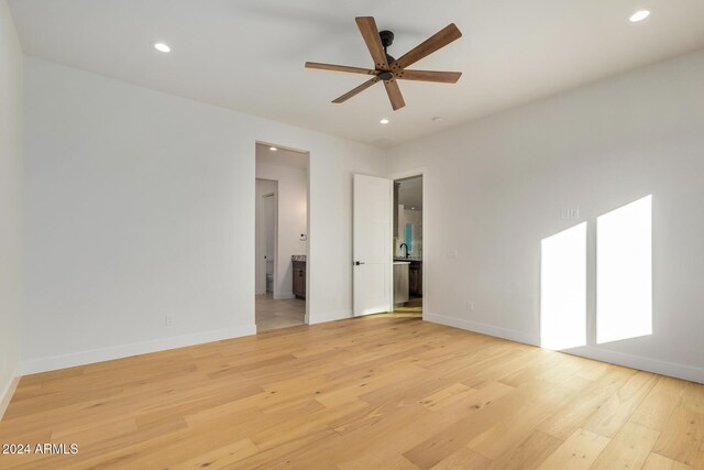 spare room featuring light hardwood / wood-style flooring and ceiling fan