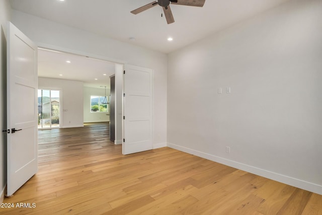 unfurnished room featuring ceiling fan and light hardwood / wood-style flooring