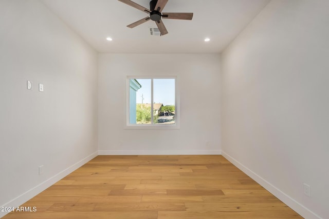 spare room featuring light hardwood / wood-style floors and ceiling fan